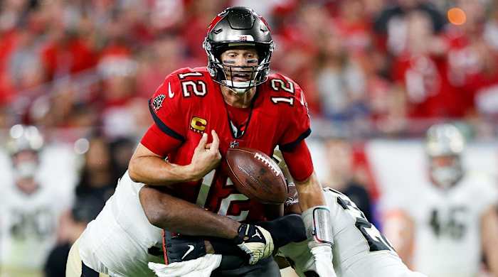 Dec 19, 2021; Tampa, Florida, USA; Tampa Bay Buccaneers quarterback Tom Brady (12) fumbles the ball in the second half against the New Orleans Saints at Raymond James Stadium.